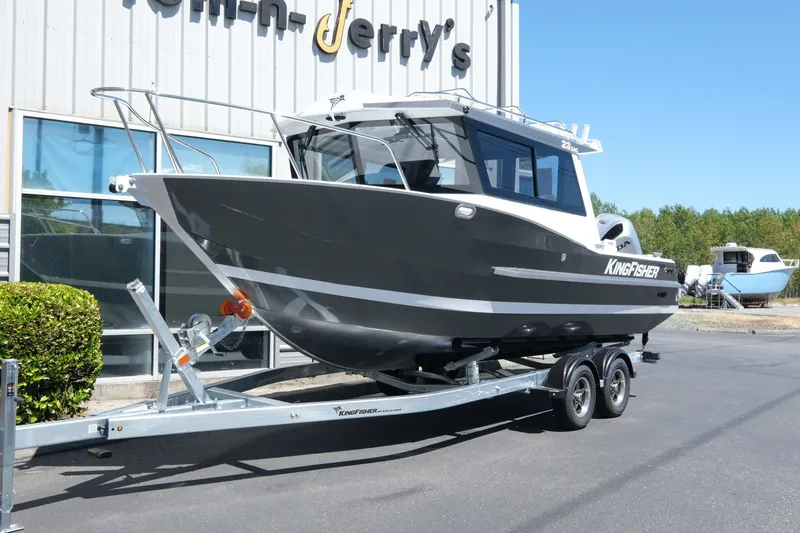 The Image of 2026 KingFisher 23 XAC boat on trailer outside dealership. - 1