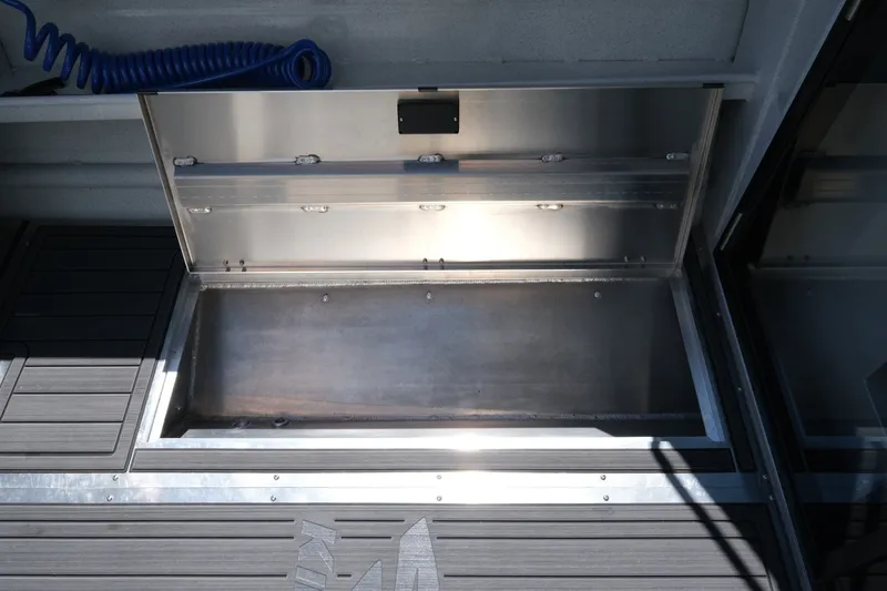 Slide: The Image of Open storage compartment on 2026 KingFisher 23 XAC boat deck. - 15