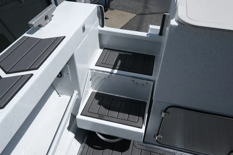 Slide: The Image of Interior view of 2026 KingFisher 23 XAC boat with non-slip steps and storage compartments. - 16