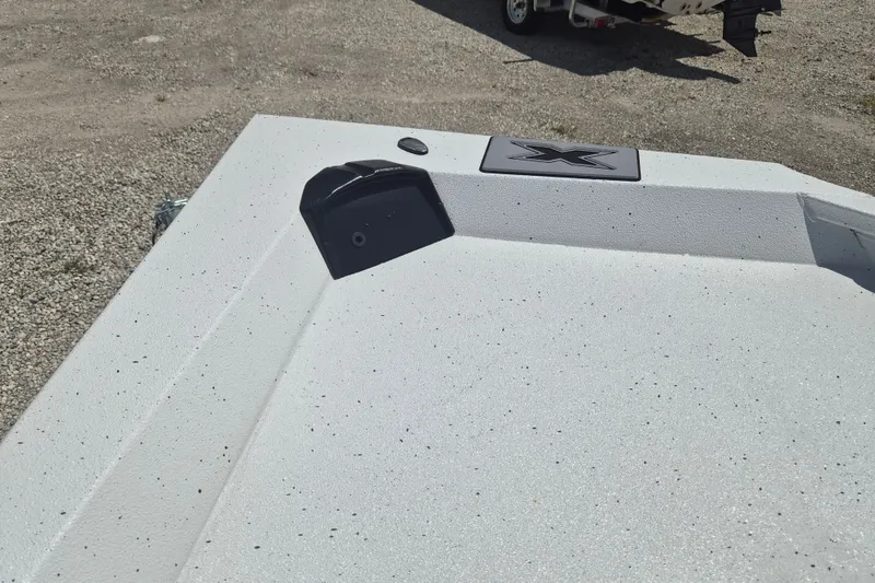Slide: The Image of 2026 Xpress H22 Bay boat deck with textured surface and logo. - 26