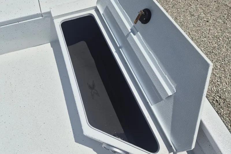Slide: The Image of Open storage compartment on 2026 Xpress H22 Bay boat, showing interior details. - 23