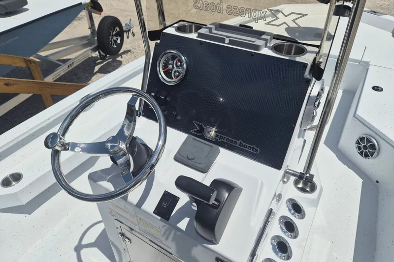 Slide: The Image of 2026 Xpress H22 Bay boat dashboard with steering wheel and control panel. - 14