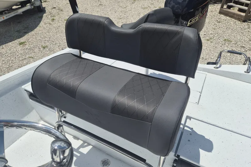 Slide: The Image of 2026 Xpress H22 Bay boat seat with diamond-stitched upholstery, outdoor setting. - 10