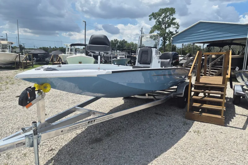 Slide: The Image of 2026 Xpress H22 Bay boat on trailer, parked outdoors under cloudy sky. - 4
