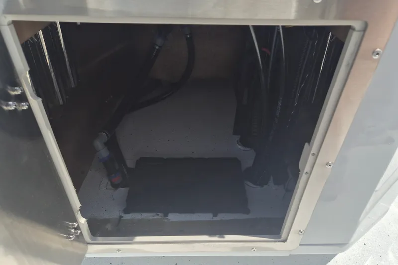 Slide: The Image of Open compartment of 2026 Xpress H22 Bay boat showing interior wiring and components. - 17