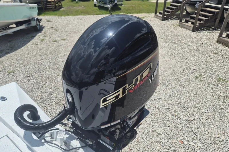 Slide: The Image of 2026 Xpress H22 Bay boat with Yamaha outboard motor in a gravel lot. - 7
