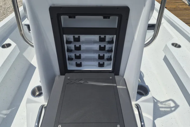 Slide: The Image of 2026 Xpress H22 Bay boat storage compartment with tackle boxes and seating. - 21