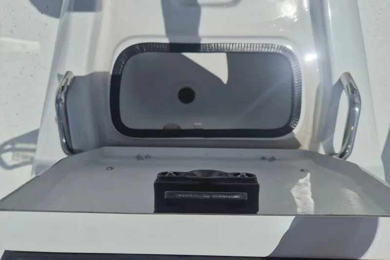 Slide: The Image of Open compartment on 2026 Xpress H22 Bay boat with stainless steel handles. - 22