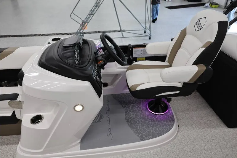 Slide: The Image of Luxurious 2026 South Bay 224 RS Tritoon helm with plush captain's chair and modern dashboard. - 21