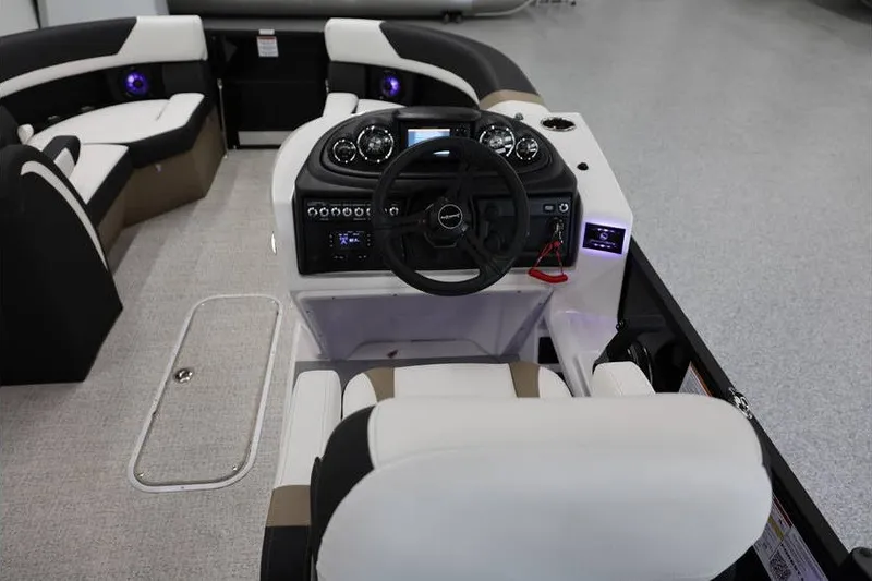 Slide: The Image of 2026 South Bay 224 RS Tritoon boat interior with modern dashboard and seating. - 16