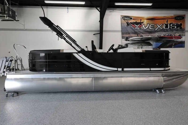 Slide: The Image of 2026 South Bay 224 RS Tritoon pontoon boat in showroom, side view. - 4