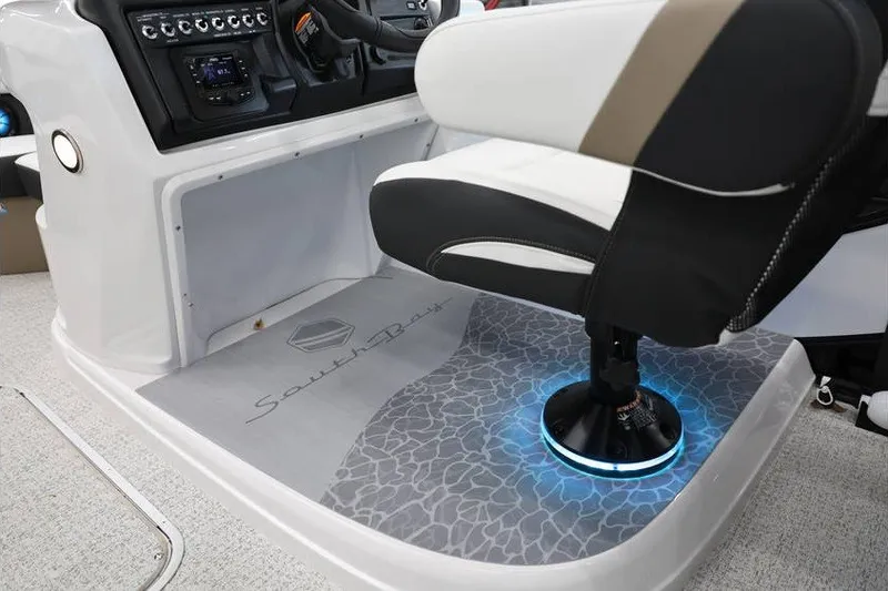 Slide: The Image of Captain's chair and console of 2026 South Bay 224 RS Tritoon boat interior. - 19