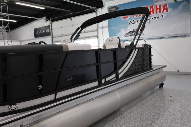Slide: The Image of 2026 South Bay 224 RS Tritoon boat displayed in showroom with Yamaha signage. - 8
