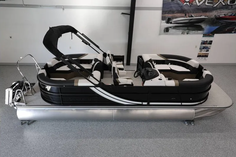 The Image of 2026 South Bay 224 RS Tritoon boat in showroom, black and white design. - 1