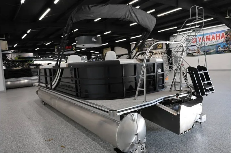 Slide: The Image of 2026 South Bay 224 RS Tritoon displayed in a showroom with sleek design and modern features. - 9