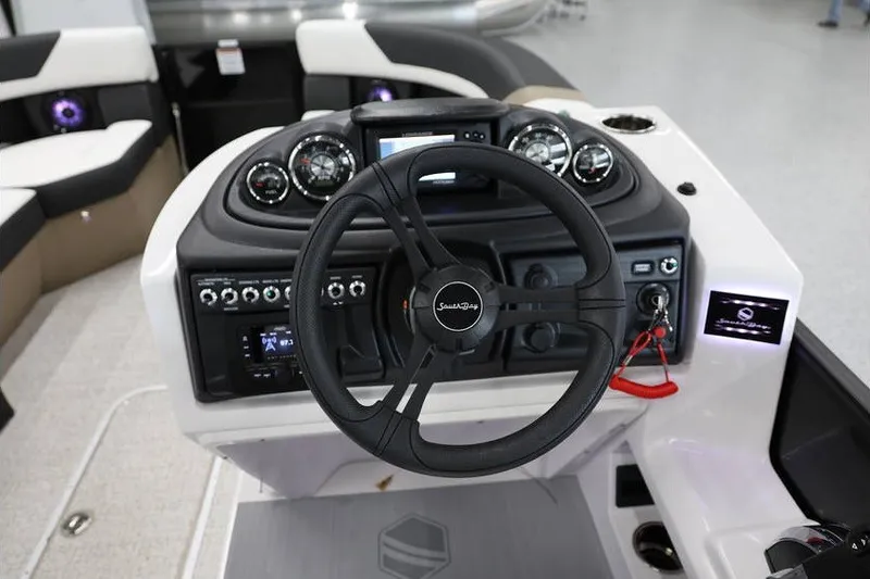 Slide: The Image of Steering console of 2026 South Bay 224 RS Tritoon with modern controls and gauges. - 17