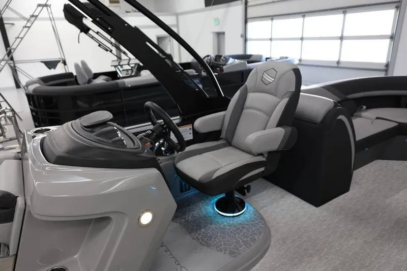 Slide: The Image of 2026 South Bay 224 RS 2.75 Hybrid Arch boat interior with modern helm and seating. - 12