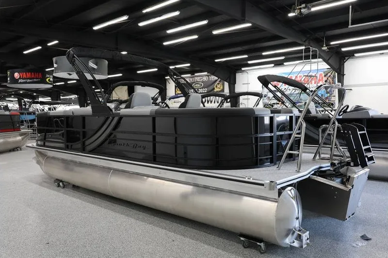 Slide: The Image of 2026 South Bay 224 RS 2.75 Hybrid Arch pontoon boat displayed in showroom. - 6