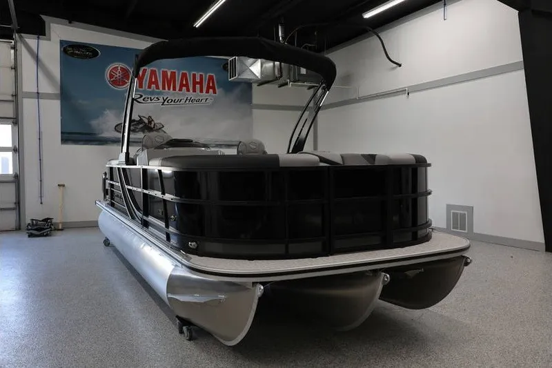 Slide: The Image of 2026 South Bay 224 RS 2.75 Hybrid Arch pontoon boat in showroom. - 2