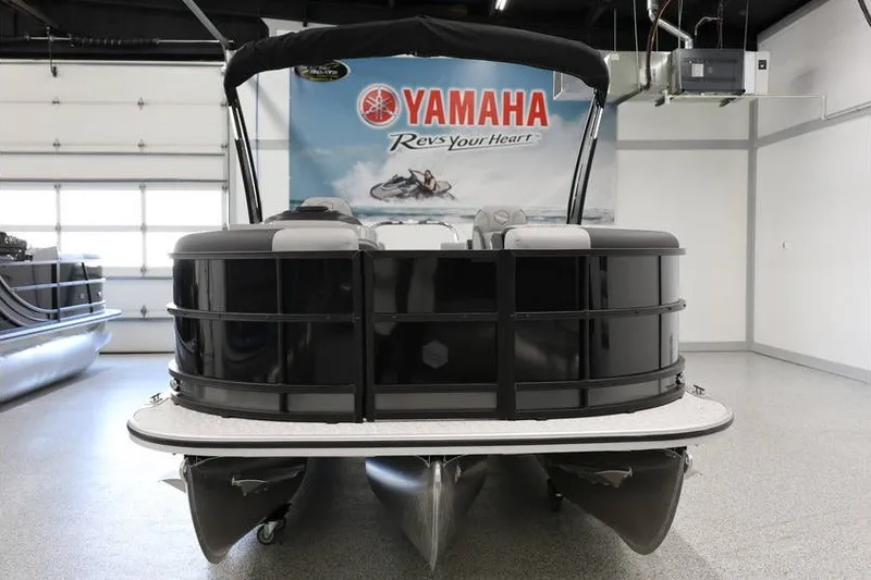 Slide: The Image of 2026 South Bay 224 RS 2.75 Hybrid Arch pontoon boat in showroom with Yamaha banner. - 3