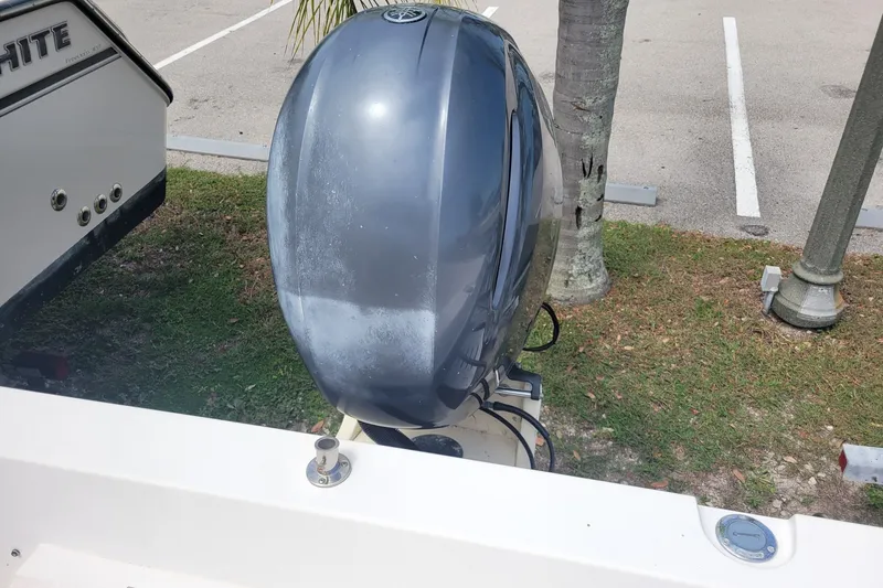 Slide: The Image of 1990 Grady-White Overnighter 204 boat with outboard motor in parking area. - 8