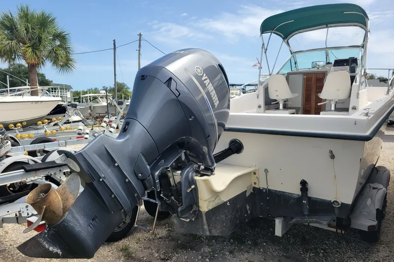 Slide: The Image of 1990 Grady-White Overnighter 204 boat with Yamaha outboard motor, parked on a trailer. - 5