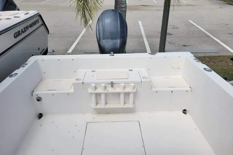 Slide: The Image of 1990 Grady-White Overnighter 204 boat interior with motor, parked in lot. - 10