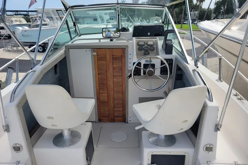 Slide: The Image of 1990 Grady-White Overnighter 204 boat interior with steering wheel and seating. - 9