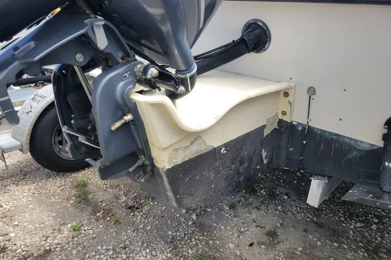 Slide: The Image of 1990 Grady-White Overnighter 204 boat transom with outboard motor, showing wear and tear. - 6