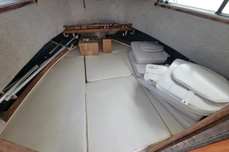 Slide: The Image of Interior cabin of 1990 Grady-White Overnighter 204 boat with cushions and storage. - 11