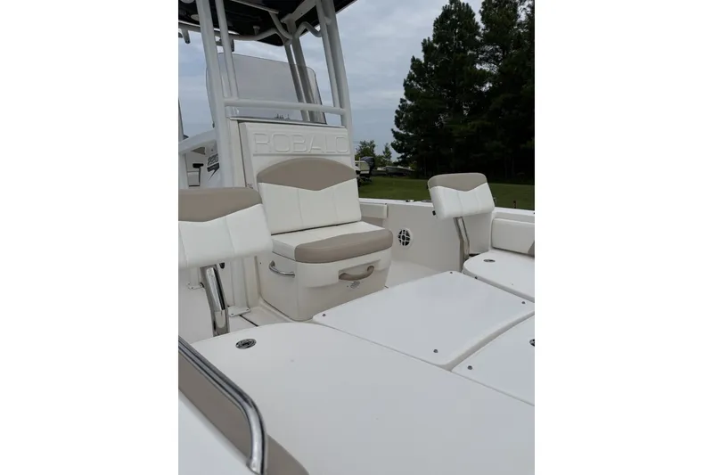 Slide: The Image of 2022 Robalo 226 Cayman boat interior with cushioned seating and sleek design. - 1