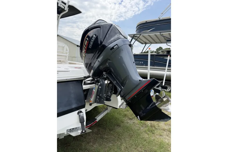 Slide: The Image of 2022 Robalo 226 Cayman boat with powerful outboard motor, displayed outdoors. - 8