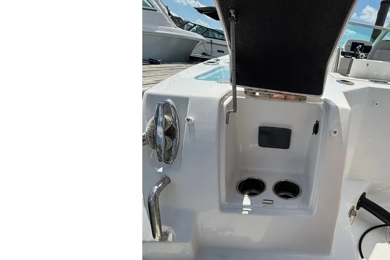 Slide: The Image of A section of a Sailfish 236 DC boat with cup holders and a small storage compartment. - 4