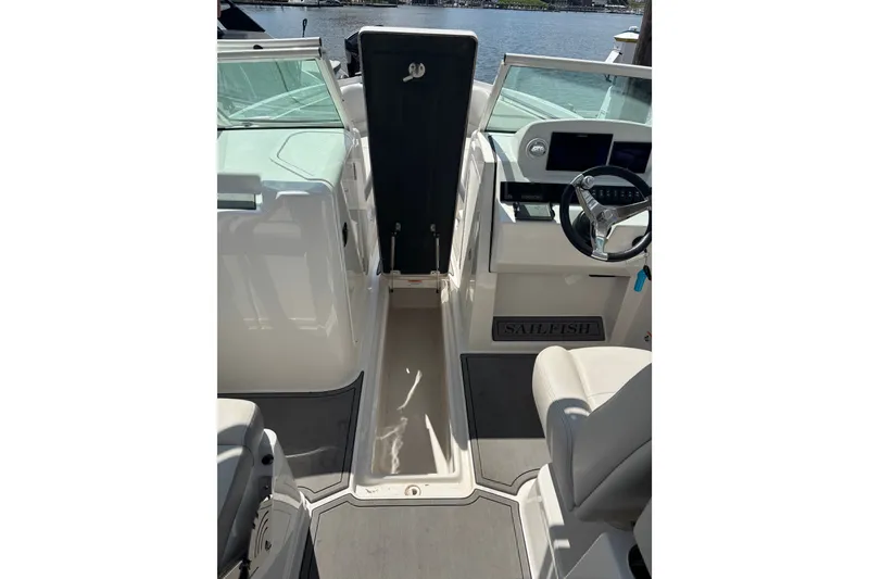 Slide: The Image of Interior view of 2026 Sailfish 236 DC boat cockpit with steering wheel and seating. - 2