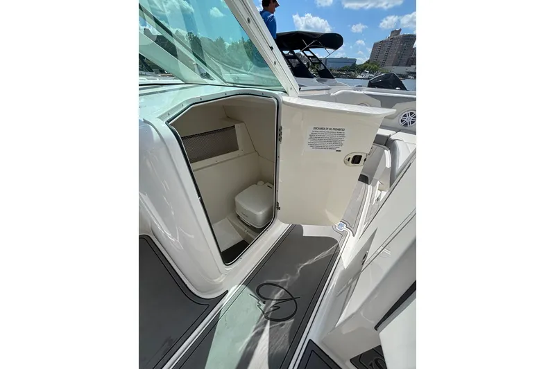 Slide: The Image of 2026 Sailfish 236 DC boat interior with open compartment and toilet. - 11