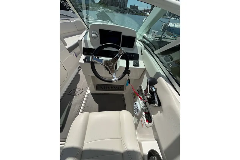Slide: The Image of Interior view of 2026 Sailfish 236 DC boat cockpit with steering wheel and controls. - 7