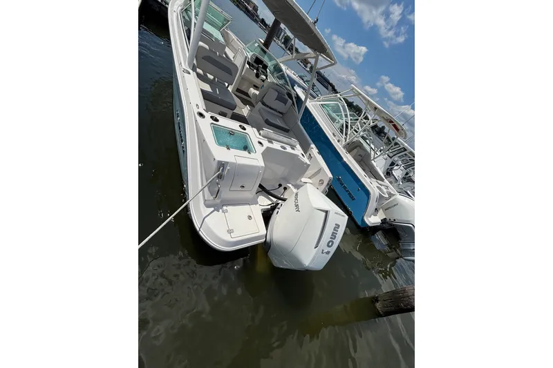 Slide: The Image of 2026 Sailfish 236 DC boat docked with Mercury outboard engine. - 5