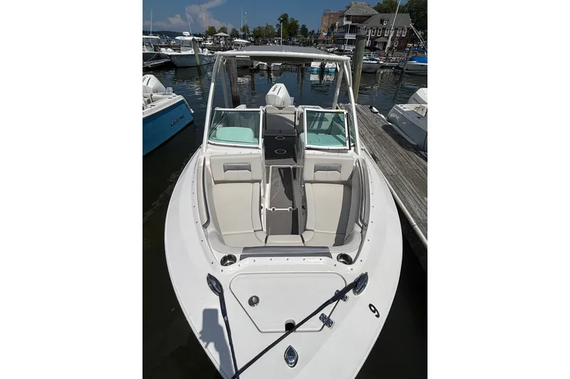 Slide: The Image of 2026 Sailfish 236 DC boat docked at marina, featuring spacious seating and sleek design. - 12