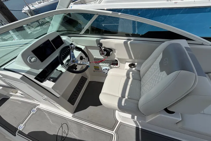 Slide: The Image of 2026 Sailfish 236 DC boat interior with modern dashboard and comfortable seating. - 8