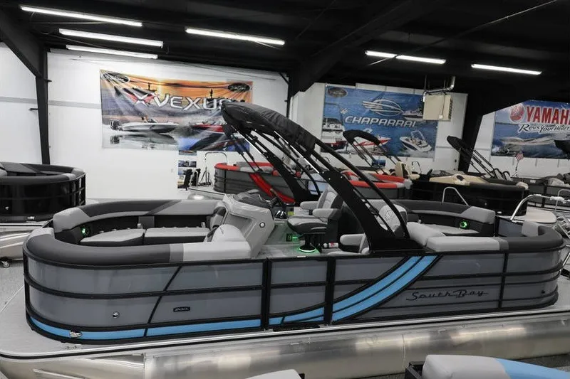 Slide: The Image of 2026 South Bay 224 RS 2.75 Hybrid Arch pontoon boat in showroom. - 3