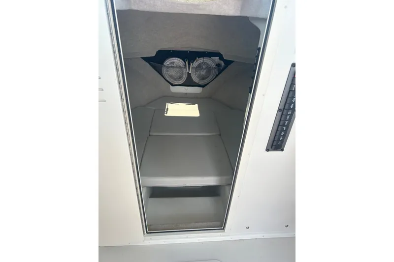 Slide: The Image of 2021 Parker 2520 XLD Sport Cabin interior with cushioned seating and storage. - 10