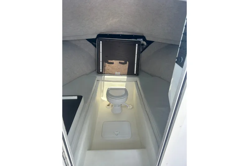 Slide: The Image of 2021 Parker 2520 XLD Sport Cabin interior with compact marine toilet. - 11