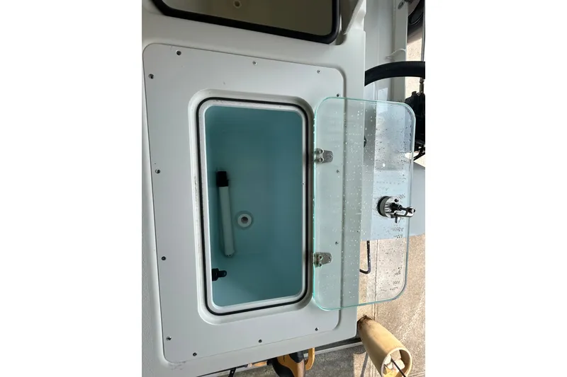 Slide: The Image of 2021 Parker 2520 XLD Sport Cabin boat compartment with glass door and latch. - 13