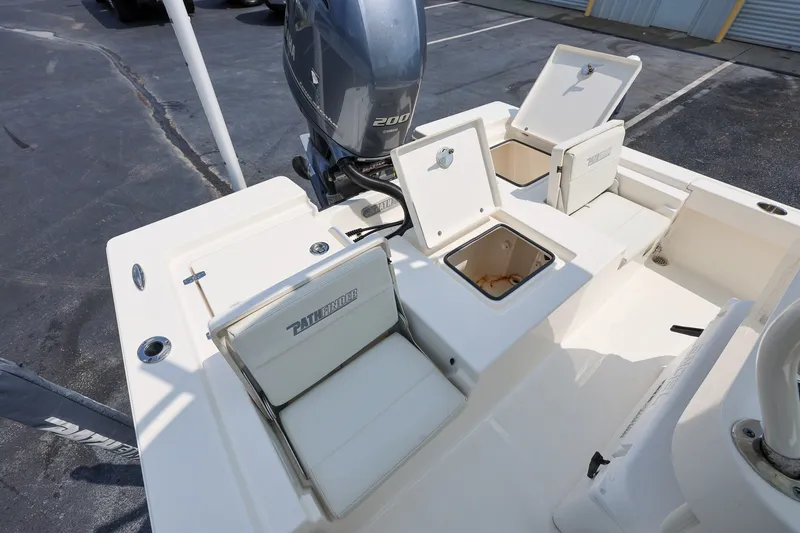 Slide: The Image of 2017 Pathfinder 2200 TRS boat with open storage compartments and Yamaha engine. - 9