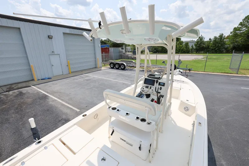 Slide: The Image of 2017 Pathfinder 2200 TRS boat parked near a warehouse, featuring a center console. - 7