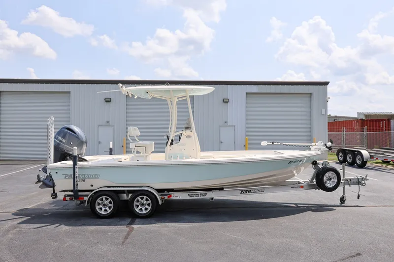The Image of 2017 Pathfinder 2200 TRS boat on trailer, parked outside industrial building. - 1