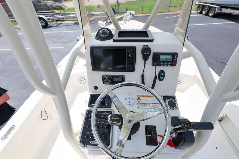 Slide: The Image of 2017 Pathfinder 2200 TRS boat console with steering wheel, navigation, and communication equipment. - 12