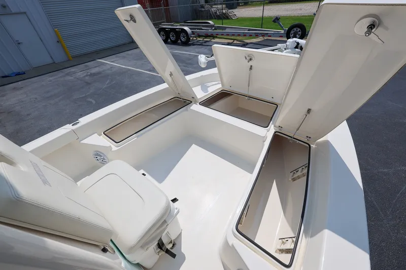 Slide: The Image of 2017 Pathfinder 2200 TRS boat with open storage compartments and seating. - 17