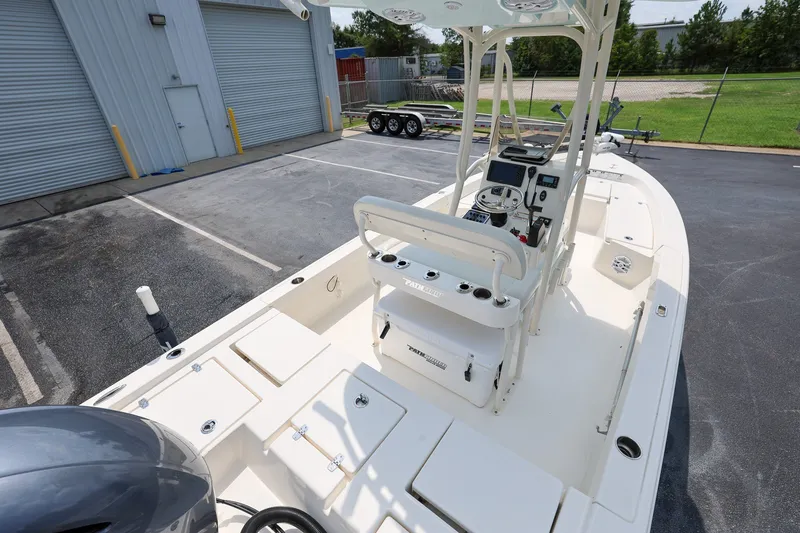 Slide: The Image of 2017 Pathfinder 2200 TRS boat in a parking lot, showcasing its deck and console. - 5