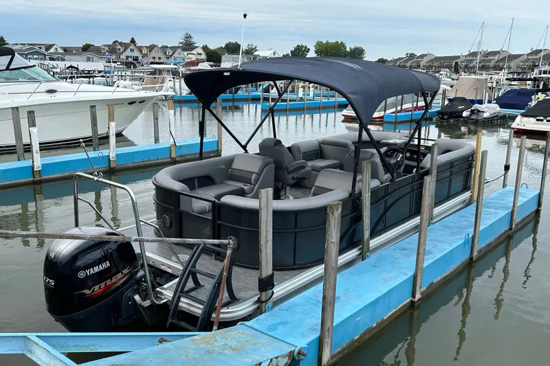 Slide: The Image of 2020 Bennington 23 SX pontoon boat docked with Yamaha outboard motor. - 13